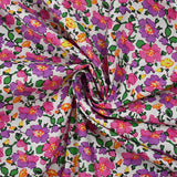 Cotton poplin printed mist of purple and pink flowers on white background