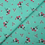 Cotton poplin printed with floral breath on aqua background