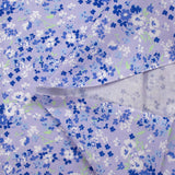 Cotton poplin printed with forget-me-not clouds, lavender background