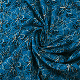 Cotton poplin printed with floral gesture on a petrol blue background