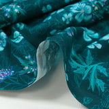 Cotton poplin printed with turquoise flowers on a dark blue background