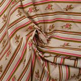 Cotton poplin printed diagonally with flowers on beige background