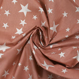 Cotton poplin printed with stars, old pink background