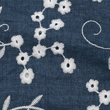 Twill de polyester brodé marguerite fond marine