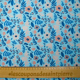 Cotton poplin printed with floral happiness on a sky blue background