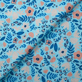 Cotton poplin printed with floral happiness on a sky blue background