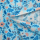 Cotton poplin printed with floral happiness on a sky blue background