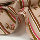 Cotton poplin printed diagonally with flowers on beige background