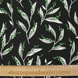 Satin viscose knit printed with a sprig of lily of the valley, black background