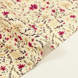 Cotton poplin printed with burgundy and beige flowers on an ecru background