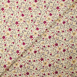 Cotton poplin printed with burgundy and beige flowers on an ecru background