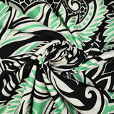 Cotton satin with green and white tribal jungle print, black background
