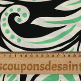 Cotton satin with green and white tribal jungle print, black background