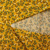 Cotton poplin printed with blue flower shoot and sunny yellow background