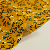 Cotton poplin printed with blue flower shoot and sunny yellow background