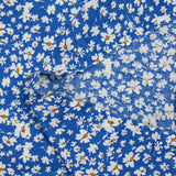 Viscose printed with white and yellow flowers, blue background