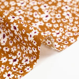 Viscose printed with white and burgundy flowers, ocher background