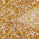 Viscose printed with white and burgundy flowers, ocher background