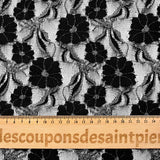 Martha metallic silver polyester lace with black background
