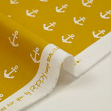 Cotton printed with white navy anchor, ocher background