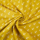 Cotton printed with white navy anchor, ocher background