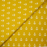 Cotton printed with white navy anchor, ocher background