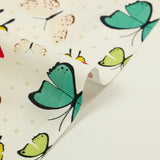 Cotton poplin printed with butterfly polka dots, beige white background