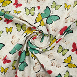 Cotton poplin printed with butterfly polka dots, beige white background