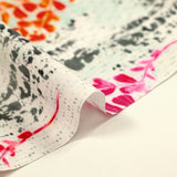 Cotton poplin printed with pink and orange foliage on a light gray background