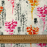Cotton poplin printed with pink and orange foliage on a light gray background
