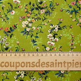 Cotton poplin printed with an idyllic flower on an apple green background
