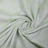 Crumpled polycotton and embroidered anise green flowers