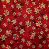 Popeline de coton imprimée flocons de neige dorés fond marbré rouge