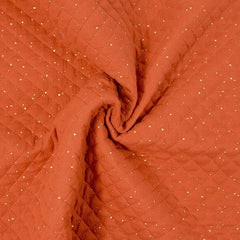 Double gaze matelassé orange confettis doré vendu au mètre
